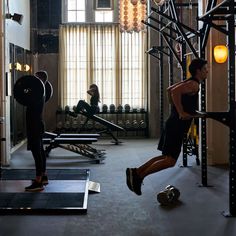 a man is running on a treadmill while another man watches from the other side