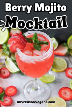 strawberry mojit mocko cocktail in a glass with limes and strawberries on the side