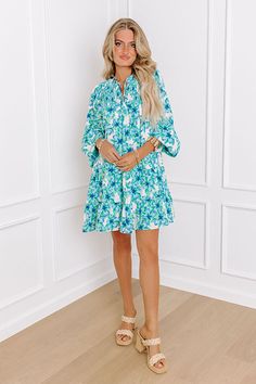 - Make memories one mimosa at a time in this darling dress! - Lightweight material with a floral print and a built-in skirt lining - A v-cut neckline with a tie - A smocked detail - Long, loose sleeves with elastic cuffs - A flowy silhouette that ends in A mini dress length hemline Measurements S : Bust 34", Hip 42", Length 34", Sleeve Length 23.5", Waist 38". M : Bust 36", Hip 44", Length 34", Sleeve Length 23.5", Waist 40". L : Bust 38", Hip 46", Length 35.5", Sleeve Length 24", Waist 42". Spring Vacation Dress With Split Neck, Floral Print Split Neck Mini Dress For Spring, Spring Green Dresses With Split Neck, Green Split Neck Dresses For Spring, Split Neck Green Dresses For Spring, Green Mini Dress For Spring Brunch, Summer Dresses With Split Neck, Spring Summer Dress With Split Neck, Spring Floral Print Mini Dress With Split Neck