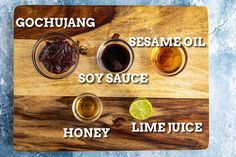 the ingredients for sesame oil, soy sauce and honey lime juice on a cutting board