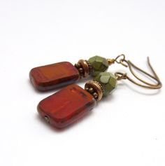 pair of red and green earrings on white background