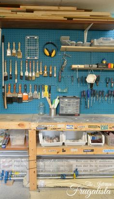 a workbench with tools hanging on the wall