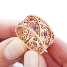 "This one of a kind 14k rose gold ring features the beautiful unique traditional yemenite filigree art. The delicate filigree art was created in the traditional yemenite filigree style, which has been practiced in the artist's family for generations. The artist's family originally designed fine jewelry for the yemenite royal family. The piece is enhanced by the magnificent sparkle of the white lavender and purple amethyst gems spread artistically throughout the filigree work. This unique piece o Filigree Wedding Ring, Filigree Ring Gold, Handmade Wedding Rings, White Lavender, Wedding Ring For Her, Amethyst Gem, 14k Rose Gold Ring, Custom Ring, Custom Ring Designs