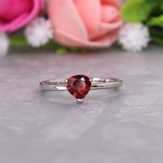 Presenting You Unique Garnet Minimalist Ring with trilliant Garnet in a minimalist style. The Garnet is All Natural And Eye Clean with minimal Styling so to give delicate and beautiful look at the same time. Perfect For Proposal Wedding Gift or Anniversary Present or Being Garnet Jan birthstone you can gift it on Birthdays too. The Lustre Refraction Along with Rich Red  Color of the Gem is definitely the query maker. Item No: skj. 09.821 Item: Natural Garnet In 925 Silver (Can Be personalized) Primary Stone: Natural garnet  Secondary Stone:  Article Weight: 2.1 gms primary stone Size:  6x6 mm Ring Length: 2.00 cm Ring Width: 0.6 cm Maintenance Tips 1. Keep the jewelry away from direct heat, water, perfumes, deodorants, and other strong chemicals.  2. Wipe the Jewellery gently with a chamoi Proposal Wedding, Minimal Ring, Anniversary Present, Minimalist Ring, Timeless Jewelry, Garnet Rings, Minimalist Rings, Birthstone Ring, Minimalist Style