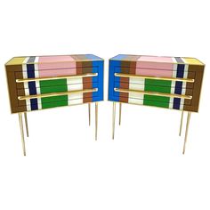 pair of multicolored wooden side tables with brass legs, each painted different colors