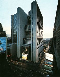 an aerial view of a city with tall buildings and billboards in the foreground