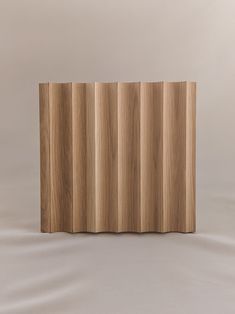 a wooden panel with vertical lines on the side, in front of a white background