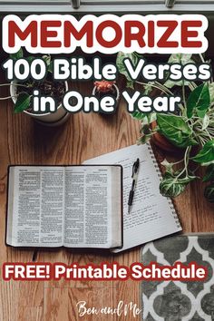 an open book sitting on top of a wooden table next to a potted plant