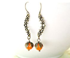 These pumpkin earrings are antiqued bronze chandelier connector with the orange bead.  ♥ Earrings measure approx. 1-3/4" long on ear wires. ♥ See more Halloween jewelry here: https://www.etsy.com/shop/iceblues/items?ref=listing-shop-header-item-count&section_id=10461899 GIFTS Each item is individually wrapped in a branded jewelry gift box. We do not include price receipts in the package. We are happy to ship directly to the recipient. EXPEDITED SHIPPING At checkout, you have the option to choose faster shipping in the drop-down menu. Ship times do NOT include production times. However, if you select expedited shipping, we will try to get your order completed faster. SHOP FAQs Please read my shop policies for my current production time and other information: http://www.etsy.com/shop/iceblue Pumpkin Chandelier, Antique Bronze Chandelier, Thanksgiving Jewelry, Jewelry Halloween, Earrings Fall, Bronze Chandelier, Pumpkin Earrings, Fall Earrings, Halloween Jewelry