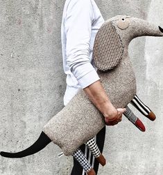 a man carrying a stuffed animal on his back