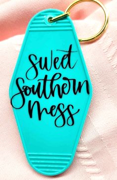 a blue keychain with the words sweet southern mess written in black on it