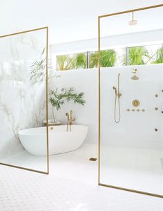 a bathroom with two mirrors and a bathtub in the middle, surrounded by greenery