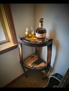 a wooden shelf with a bottle and glass on it