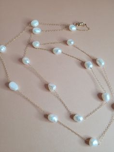 This is a 14k gold filled fresh water pearl necklace.  Very delicate chain,  the pearls are 8-9mm and are potato shape.  Some sides are flat,  no 2 pearls are shaped exactly alike and they are so beautiful though! This necklace has a magnetic clasp to make it so easy to put on. White Single Strand Pearl Necklace With 14k Gold Filled, White Single Strand Pearl Necklace In 14k Gold, White Pearl Chain Necklace In 14k Gold Filled, White Pearl Chain Necklace In 14k Gold, White Pearl Necklace With 14k Gold-filled Pearl Pendant, White 14k Gold-filled Pearl Pendant Necklace, Classic 14k Gold Filled Pearl Necklace For Wedding, Delicate White Briolette Pearl Necklace, White Pearl Pendant Necklace In 14k Gold Filled