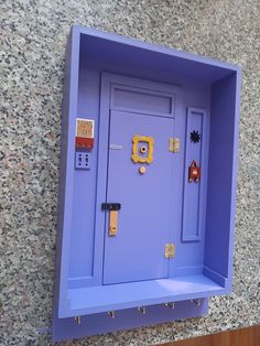 a purple wall mounted cabinet with keys and locks