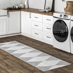 a washer and dryer in a white kitchen