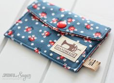 a small wallet with a sewing machine on it