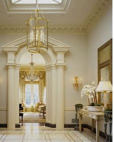 an elegant foyer with chandelier, marble floors and large windows on both sides