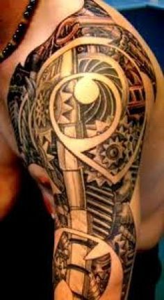 a man's arm with an abstract tattoo design on the arm and shoulder area