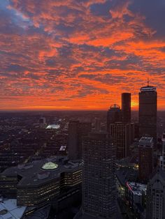 an orange and red sky is seen over the city at sunset in this aerial photo