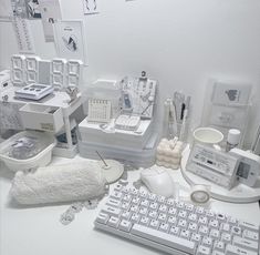 a white desk topped with lots of different types of office supplies and gadgets