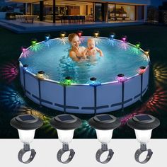 an in ground swimming pool with lights around it and three baby monitors on the side