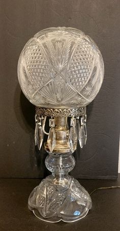 an antique glass candle holder on a table