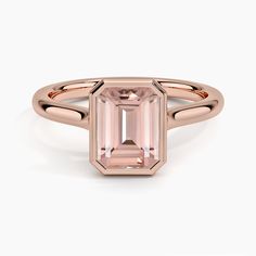 an emerald cut pink tourmaline ring on a white background