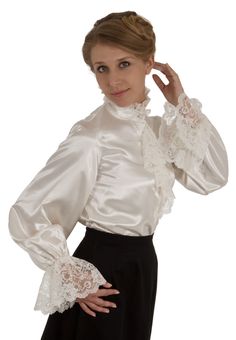 What could be more romantic and feminine than shimmering satin and frothy lace? The satin blouse features an attached lace trimmed jabot and closes with satin-covered buttons, and very full long sleeves with a deep ruffle of lace at the cuff. The blouse has a button closure down the front and comfortable elastic at the wrists. Proudly designed and made in America by Recollections. Poly satin; Dry clean or hand wash.The model finishes the look with a skirt which is priced separately. Long Sleeve Satin Top For Wedding, Evening Satin Blouse With Ruffles, Formal Lace Blouse With Ruffles, Formal Blouse With Lace Trim And Ruffled Collar, Formal Satin Blouse With Ruffles, Elegant Blouse With Lace Trim And Ruffled Collar, Elegant Satin Blouse With Ruffles, Elegant Satin Ruffled Tops, Elegant Satin Tops With Ruffles