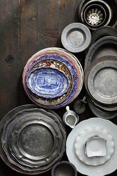 an assortment of dishes and bowls are laid out on the floor next to each other