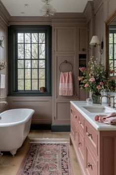 a bath room with a tub a sink and a rug on the floor in front of a window