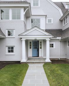 a house with white trim and blue door