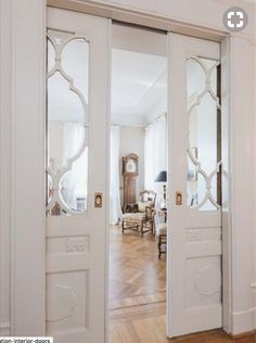 an open door with mirrored glass on the front and side doors, in a living room