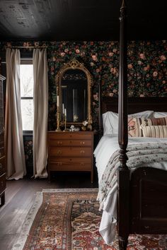 a bed sitting in a bedroom next to a dresser with a mirror on top of it