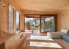 a living room filled with furniture and lots of windows