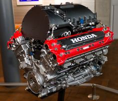 the honda engine is on display at the museum for people to see and take pictures