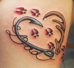 a heart shaped tattoo on the side of a woman's thigh with paw prints