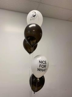 three balloons with the words nice for what written on them are hanging from a ceiling