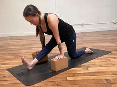 a woman in black shirt and leggings doing yoga