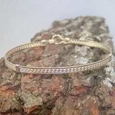 A pretty little bracelet of four strands of 14kt gold filled wire--two twist in the middle and two plain square on either side. So sweet and feminine! This one stacks nicely with a number of my other bangle-style bracelets! The sturdy built-in hook and eye clasp is easy to get on and off by yourself. Choose your size for a perfect custom fit! This design is also available in sterling silver and two-tone. Add on a jewelry polishing cloth to keep your bracelet--and ALL your jewelry--shiny clean! h Nickel-free Gold Beaded Bracelets In Sterling Silver, Nickel Free Gold Beaded Bracelets In Sterling Silver, Adjustable Gold Sterling Silver Bangle, Gold Wire Wrapped Wrap Bracelet As A Gift, Adjustable Gold Wire Wrapped Wrap Bracelet, Bohemian Gold Sterling Silver Bangle Bracelet, Gold Bohemian Bangle Sterling Silver Bracelet, Gold Sterling Silver Nickel-free Bangle, Gold-plated Nickel-free Sterling Silver Bangle