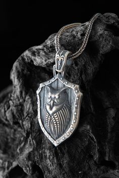 This silver owl figure necklace is a unique and eye  catching piece of jewelry that is perfect for anyone with a love of nature or a fascination with these wise and mysterious birds. The necklace is made of sterling silver and features a detailed design of an owl, with its piercing gaze and intricate feathenecklace expertly captured in the design. The intricate detailing on the necklace makes it a standout piece that is sure to become a favorite in your collection. Wear it alone as a statement p Viking Style Sterling Silver Pendant Jewelry, Viking Sterling Silver Pendant Jewelry, Viking Style Sterling Silver Pendant, Viking Style Sterling Silver Nickel-free Necklace, Nickel-free Viking Style Sterling Silver Necklace, Nickel-free Sterling Silver Viking Necklace, Handmade Viking Sterling Silver Necklaces, Viking Style Nickel Free Necklaces For Gift, Viking Style Sterling Silver Necklace Gift