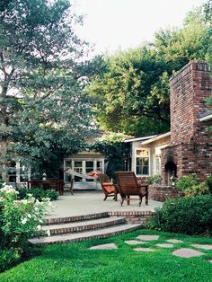 an outdoor patio with steps leading up to the house