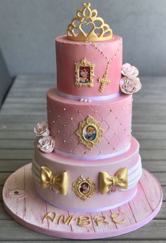 a three tiered cake with princess pictures on it