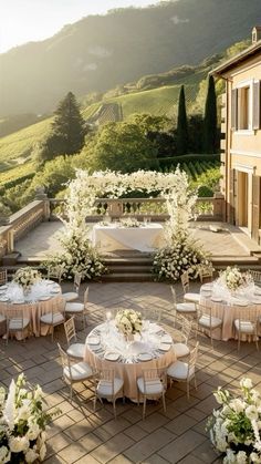 an outdoor dining area with tables and chairs set up for a formal function in the sun