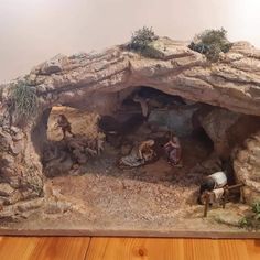 a nativity scene with figurines and figures in an indoor rock - built cave