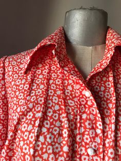 "Orange and white lovely buttoned shirt from 1960 Sturdy thick fabric in straight line, loose fit, closes with cute round white buttons in the shape of a ball ⚽️ Pointed collars, short sleeves with revers and lovely daisy/floral pattern all the way around Authentic 1960s piece for all the 60's lovers... ‼️Be aware - only one piece is available----- 🌀MEASUREMENTS: (taken while laying flat and un-stretched) *BUST : (pit to pit) 52 cm / 20.5\" *WAIST: 54 cm / 21.2\" *LENGTH - Measured from shoulde White Shirt With Vintage Print For Spring, White Vintage Print Shirt For Spring, Orange Buttoned Blouse For Spring, Orange Button Blouse For Spring, Vintage Long Sleeve Orange Shirt, Vintage Orange Long Sleeve Shirt, White Retro Shirt For Spring, Vintage Red Blouse For Daywear, Orange Collared Shirt With Floral Print