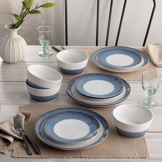 a place setting with blue and white dishes