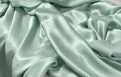 Gorgeous, solid mint green silk with a light shine. One side is shiny, one side is dull.  This fabric makes a beautiful top, Kimono, robe, dress, pajamas...  100% silk, dry clean recommended. Great fabric for apparel. Monitor colors may vary.  Listing is for 1 yard. 36" x 52/53". Wide goods! Light Mint Green Dress, Green Silk Fabric, Mint Green Fabric, Dress Pajamas, Light Green Fabric, Prom Dress Inspo, Charmeuse Fabric, Mint Green Dress, Light Mint Green