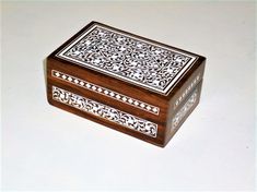 a decorative wooden box sitting on top of a table