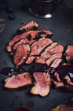 slices of sliced meat sitting on top of a cutting board